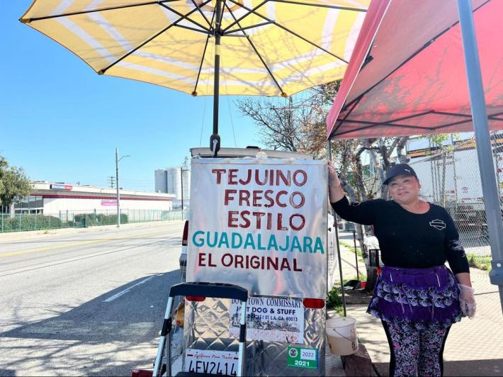 Street vendor poses next to her Tejuino cart.